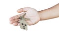 Holding house keys on house shaped keychain in front of a new ho Royalty Free Stock Photo