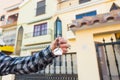 Hands holding house keys on house shaped keychain in front of a new home. Royalty Free Stock Photo