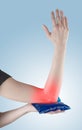 Holding ice gel pack on elbow. Royalty Free Stock Photo