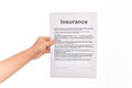 Holding Insurance paper form over isolated white background Royalty Free Stock Photo