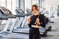 Holding jump rope. Young beautiful woman in sportive clothes have fitness day in the gym Royalty Free Stock Photo