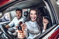 Photo of young couple sitting inside new car Royalty Free Stock Photo