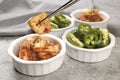 Holding kimchi in pair of chopsticks Royalty Free Stock Photo