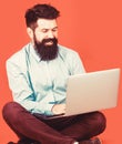 Holding laptop computer.Young businessman using his laptop, pc. Smiling handsome bearded man worker laptop. Happy young Royalty Free Stock Photo