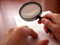 Holding a magnifying lens Royalty Free Stock Photo