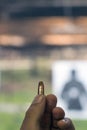 Holding 9mm bullet in hand Royalty Free Stock Photo