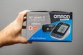Holding Omron M7 Intelli IT Automatic Upper Arm Blood Pressure Monitor