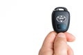 Holding onto a car Toyota car key and showing off the Toyota logo Royalty Free Stock Photo