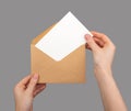 Holding open envelope with white blank card inside, postcard mockup Royalty Free Stock Photo