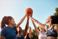 Holding our love for the sport high. a diverse group of sportswomen holding a basketball together before playing a game Royalty Free Stock Photo