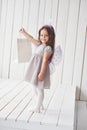 Holding the package. Beautiful little girl with fairy costume having fun posing for the pictures Royalty Free Stock Photo