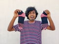 Holding a pair of stripped socks. Atlast he found the missing socks. White background