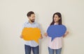 Holding paper speech bubbles couple playful banter faces smiling and joy. Speech bubbles capture essence of light