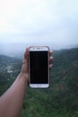 holding the phone on the hill