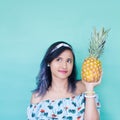 Holding a pineapple. Yellow nails. Girl hands. Royalty Free Stock Photo