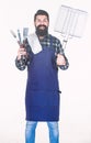 Holding portable grilling cooking tools. Bearded man holding barbecue grilling tools. Happy hipster using metal grilling