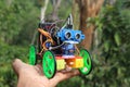 Holding a programmable robotic car that is capable of avoiding obstacles in is path and change the direction of movement using