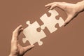 Holding puzzle. Business solutions, success and strategy concept. Two hands trying to connect couple puzzle piece on Royalty Free Stock Photo