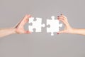 Holding puzzle. Closeup hand of connecting jigsaw puzzle. Business solutions, success and strategy concept. Two hands Royalty Free Stock Photo