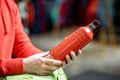 Holding red thermos for hiking Royalty Free Stock Photo
