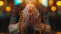 and holding rosary against cross and praying to God at church. Royalty Free Stock Photo