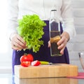 Holding a salad and olive oil bottle