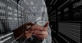 Holding smartphone IT professional interacting in high-tech data space, with holographic panels Royalty Free Stock Photo