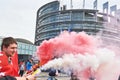 Holding smoke grenade in front of Parliament