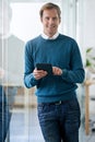 Holding success firmly in my hands. Portrait of a handsome young businessman working on a digital tablet in the office. Royalty Free Stock Photo