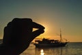 holding the sun with a finger at a very beautiful sunset. Beautiful Sunset in tropical Komodo island, Labuan Bajo, Fores,