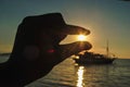 holding the sun with a finger at a very beautiful sunset. Beautiful Sunset in tropical Komodo island, Labuan Bajo, Fores,