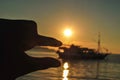 holding the sun with a finger at a very beautiful sunset. Beautiful Sunset in tropical Komodo island, Labuan Bajo, Fores,