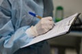 Holding a tablet in his hands, the veterinary anesthesiologist makes notes in the patient& x27;s chart. During Royalty Free Stock Photo