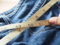 Holding tapeline on waist of jeans Royalty Free Stock Photo