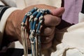 Holding techelet blue tzitzit strings during Jewish prayer