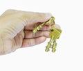 Holding three brass keys by hand