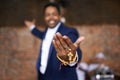 Holding on to religion. Portrait of an ethnic man standinf on a stage and holding his rosary beads.