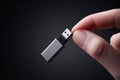 Holding a USB drive in hand against a dark background in a tech-focused setting Royalty Free Stock Photo