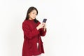 Holding and Using Smartphone Of Beautiful Asian Woman Wearing Red Shirt Isolated On White Royalty Free Stock Photo