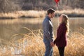 20 something couple standing at lake looking into each others eyes Royalty Free Stock Photo