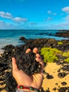 Holding a volcanic rock at the beach Royalty Free Stock Photo