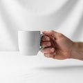 Holding a white ceramic mug with a smooth surface and a simple Royalty Free Stock Photo