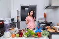 Holding wooden spatula turner in kitchen room Royalty Free Stock Photo