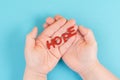 Holding the word hope in the palm of the hands, trust and believe concept, having faith in the future, hopeful positive mindset Royalty Free Stock Photo