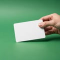 Holds a blank white rectangular card with rounded corners against a smooth Royalty Free Stock Photo
