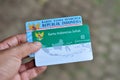 Holds a Healthy Indonesia Card Health Insurance card from the Government of Indonesia and Indonesian identity card