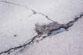 Hole in the asphalt with cracks