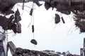 A hole in the body of a building with a pile of construction debris and concrete fragments hanging on the rebar against Royalty Free Stock Photo