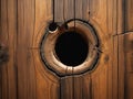 Hole in brown wooden wall or floor. Damage, broken wood surface. Horizontal Royalty Free Stock Photo