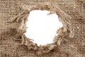 Hole in burlap. Torn piece of burlap fabric with a hole in the middle texture Royalty Free Stock Photo